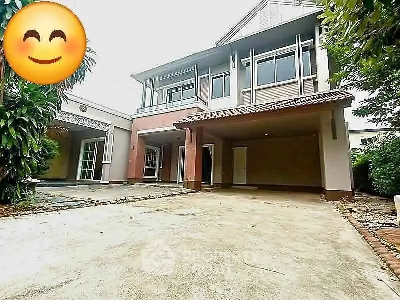 Spacious two-story house with large driveway and lush greenery, perfect for family living.