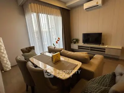 Elegant living room with modern furniture and natural light, perfect for cozy gatherings.