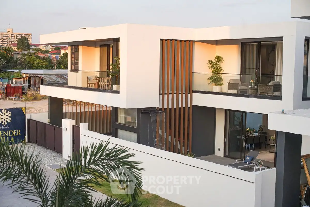 Modern luxury villa with spacious balconies and sleek architectural design.