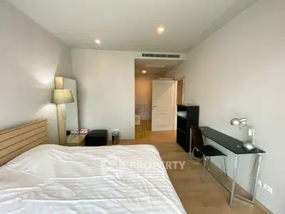 Spacious bedroom with modern decor and study area, perfect for comfortable living.