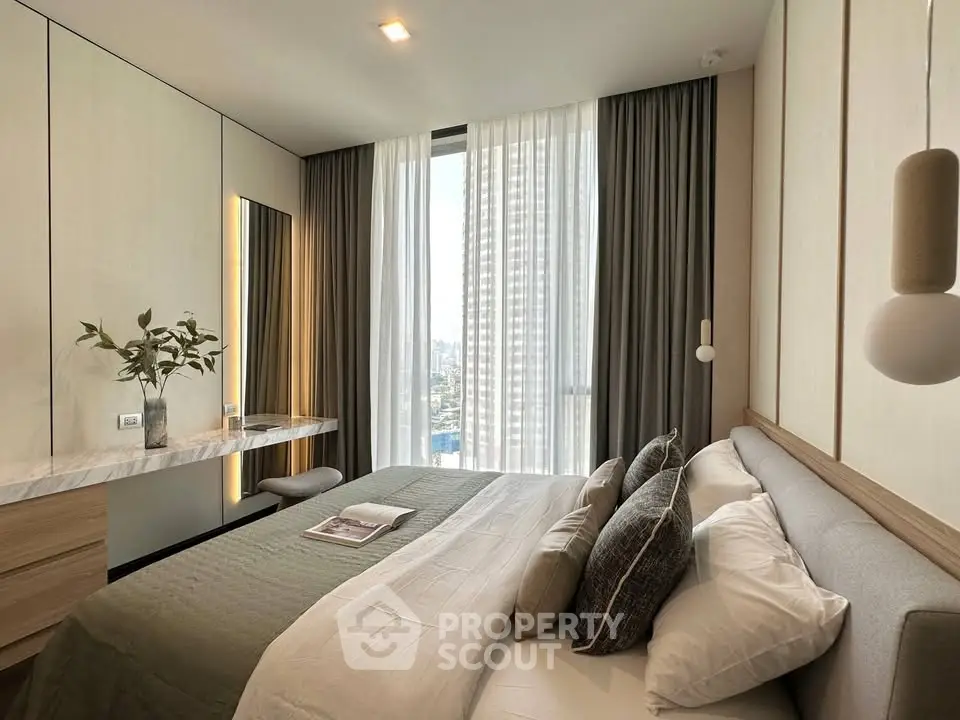Luxurious bedroom with modern decor and stunning city view from large window.