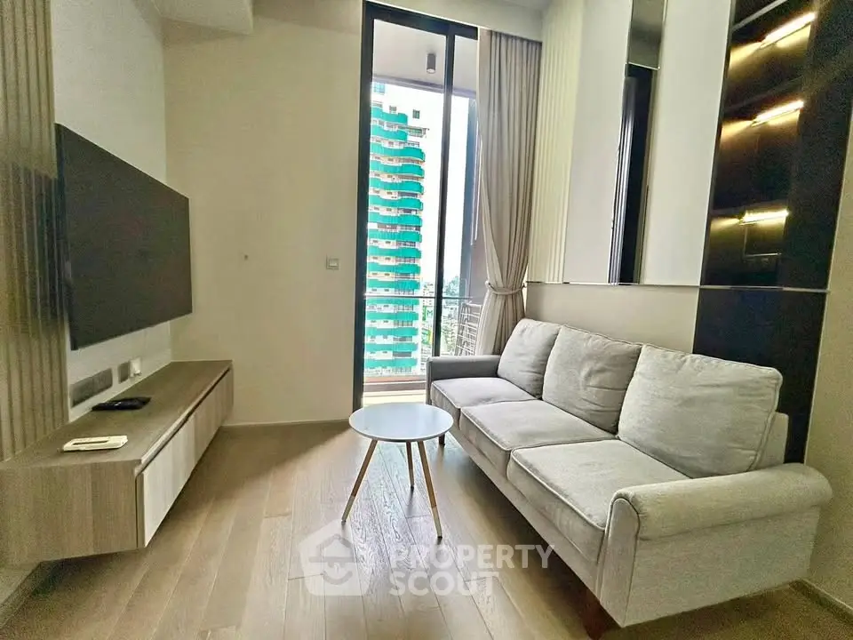 Modern living room with sleek design, featuring a cozy sofa, wall-mounted TV, and a view of the cityscape.