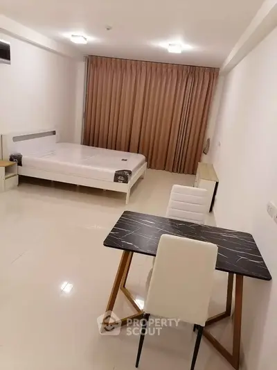 Modern minimalist bedroom with sleek furniture and neutral tones