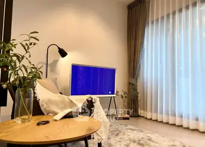 Modern living room with stylish decor and large window drapes