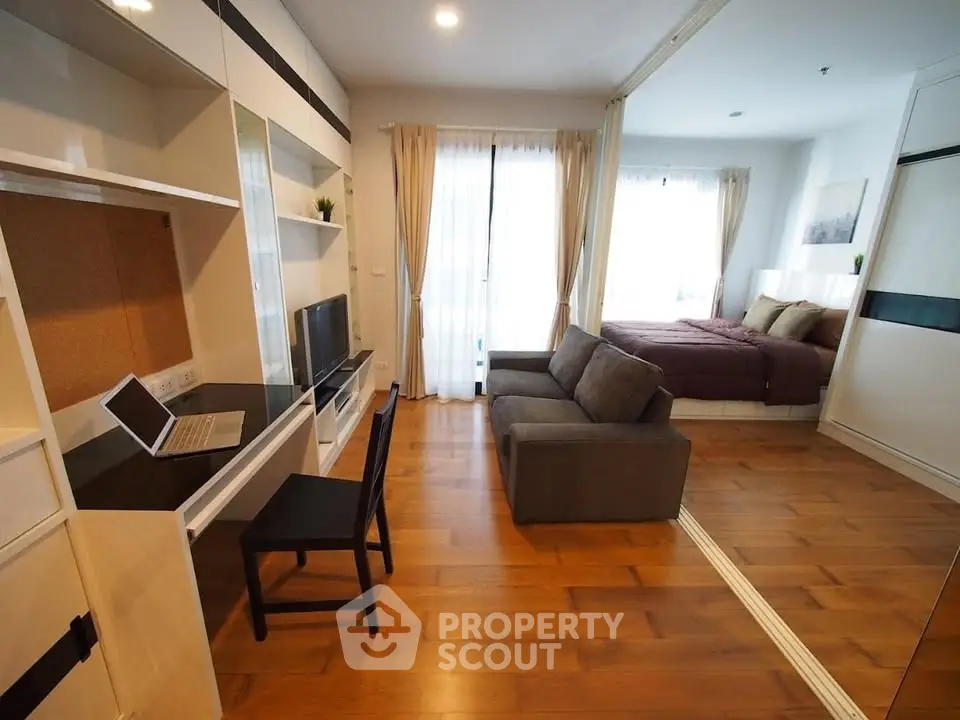 Modern studio apartment with open layout, featuring a cozy living area and stylish bedroom.