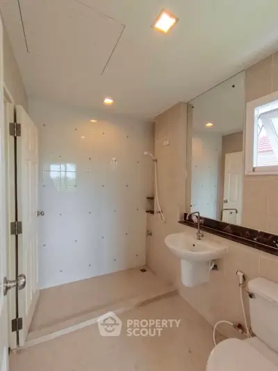 Modern bathroom with sleek fixtures and spacious shower area