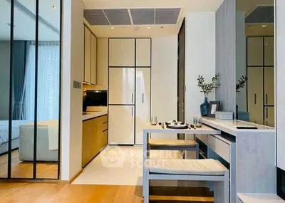 Modern kitchen with sleek design and integrated dining area in a stylish apartment.
