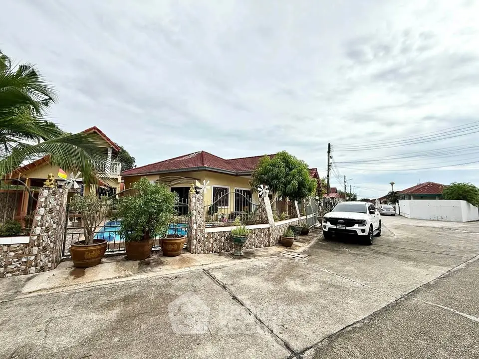 Charming suburban home with a spacious driveway and lush greenery, perfect for family living.