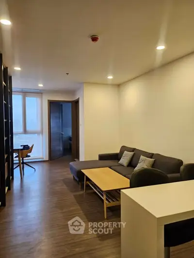 Modern living room with sleek furniture and city view, perfect for urban living.