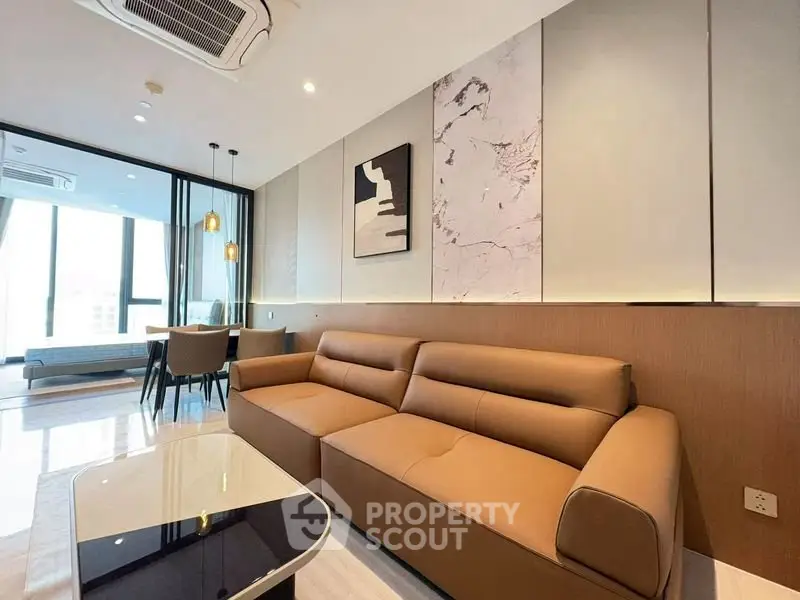 Modern living room with stylish decor and large windows in a luxury apartment.