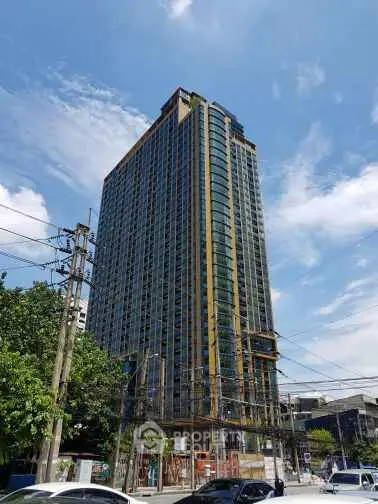 Stunning high-rise building with modern architecture and expansive glass windows in urban setting.