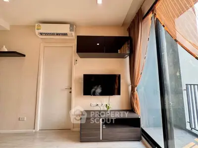 Modern living room with sleek TV setup and balcony view