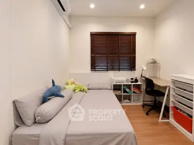 Cozy bedroom with modern decor, featuring a comfortable bed, study desk, and ample storage space.