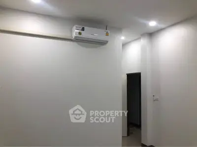 Minimalist interior with air conditioning unit and recessed lighting