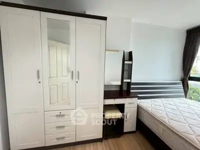 Spacious bedroom with modern wardrobe and comfortable bed in a bright apartment.