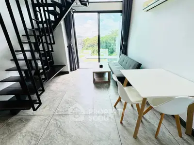 Modern duplex living room with sleek staircase and large windows offering a scenic view.
