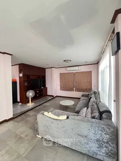 Spacious living room with modern furniture and large windows for natural light.