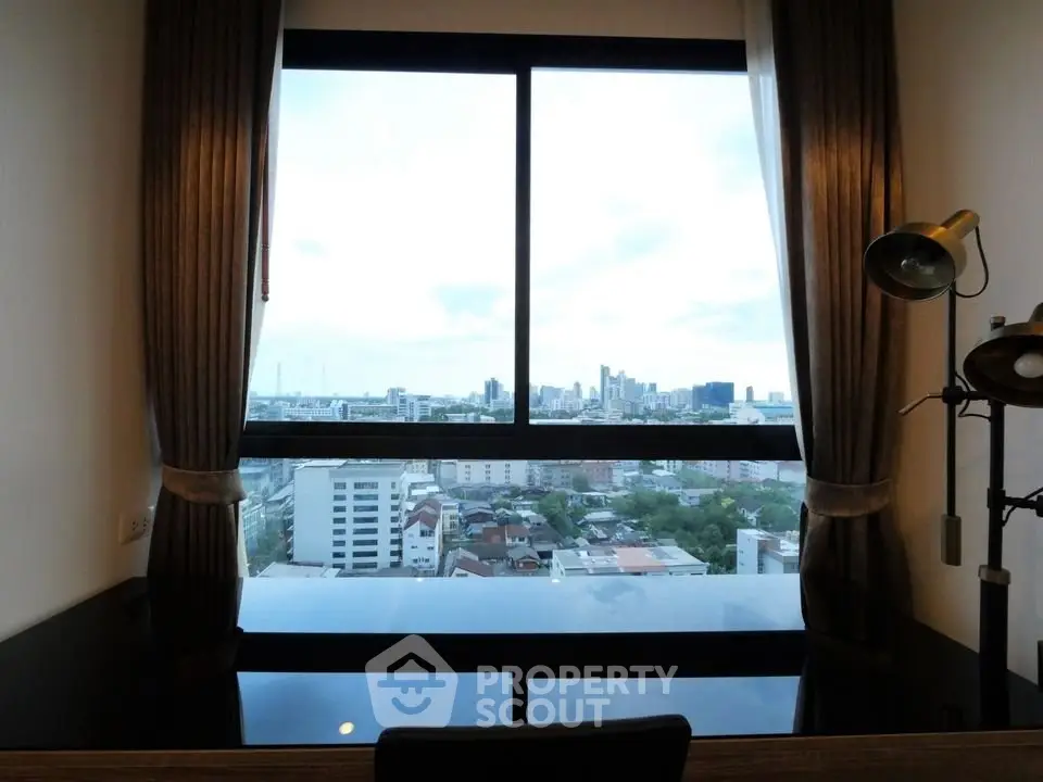 Stunning city view from a modern high-rise apartment window, perfect for urban living.