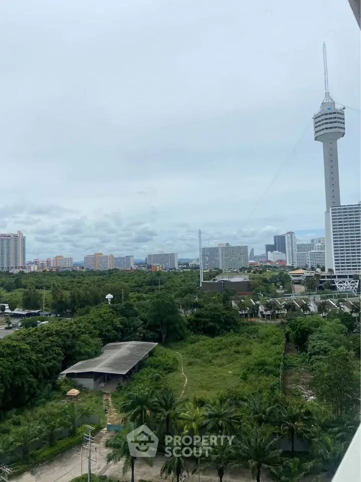 Stunning cityscape view with lush greenery and iconic tower, perfect for urban living enthusiasts.