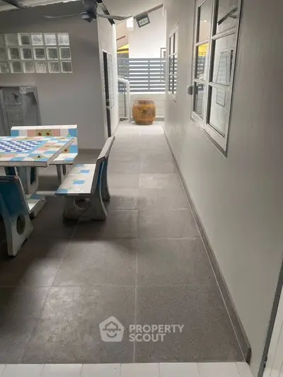 Charming outdoor patio with colorful seating and modern design, perfect for relaxation and entertainment.