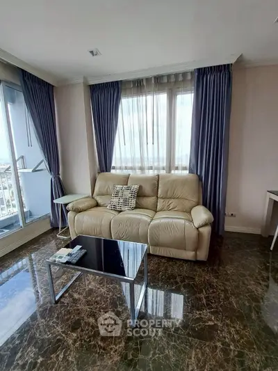 Elegant living room with marble floors and plush leather sofa in a high-rise apartment.