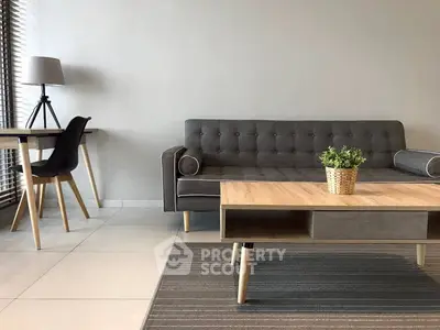 Modern living room with stylish gray sofa and wooden coffee table, perfect for contemporary living.