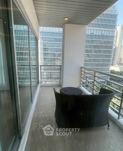 Spacious balcony with city view in modern high-rise building