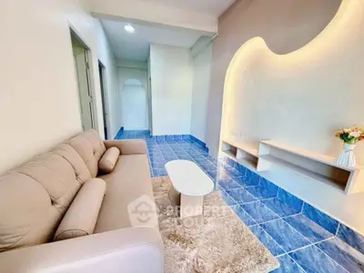 Charming living room with modern decor and cozy sofa on stylish blue tiles.