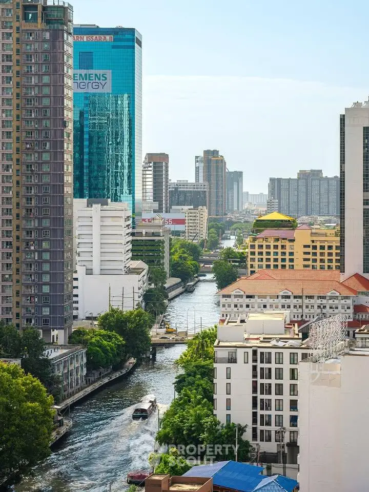 Stunning urban view with river and modern high-rise buildings, perfect for city living enthusiasts.