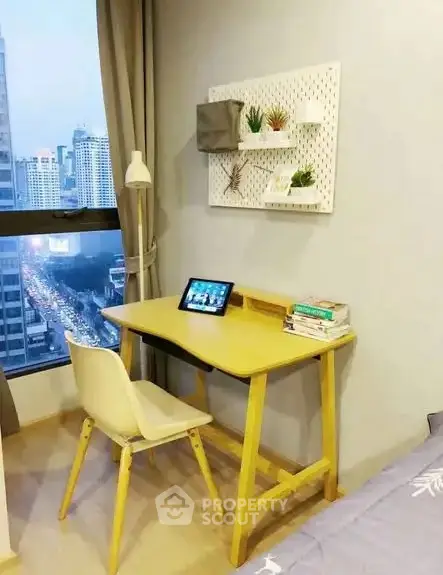 Cozy study nook with city view, featuring a modern desk and chair, ideal for productivity.