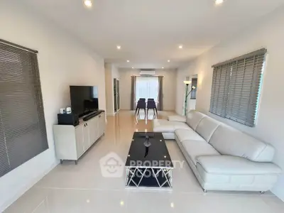 Spacious modern living room with sleek furniture and natural light