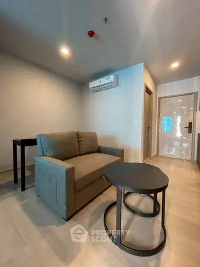 Modern living room with sleek furniture and air conditioning in a stylish apartment.