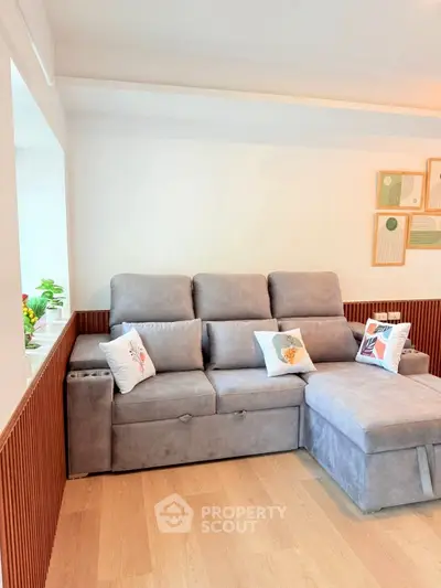 Cozy living room with plush gray sofa and stylish decor accents