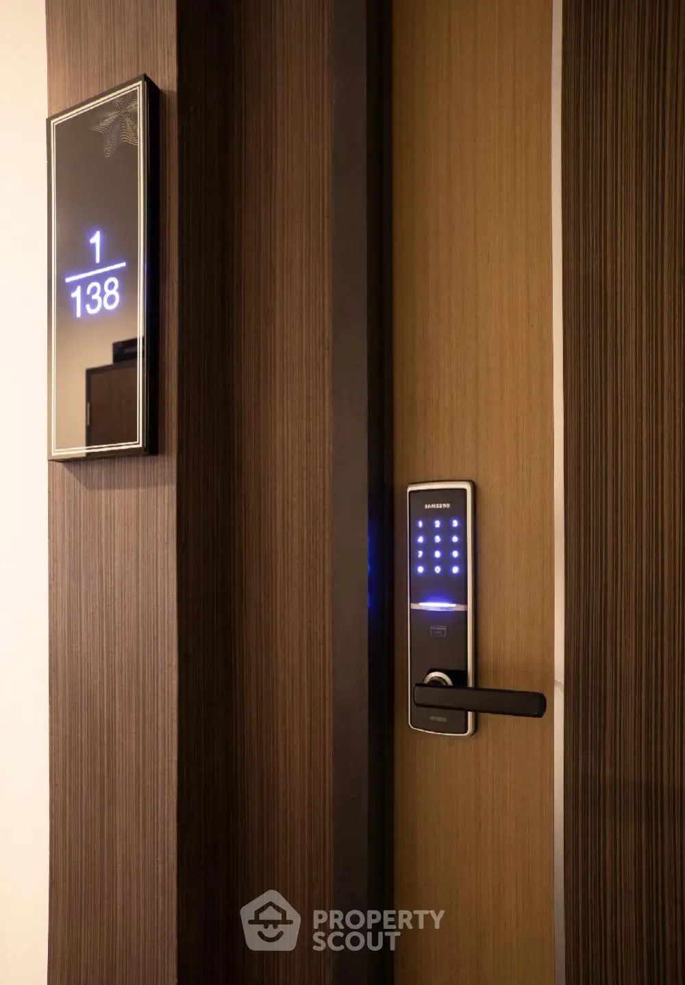 Modern apartment door with digital lock and room number display