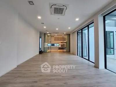 Spacious modern living room with open layout and large windows