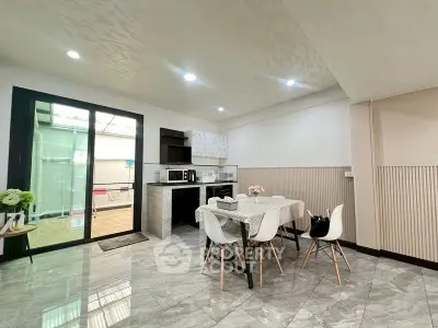 Modern dining area with sleek kitchen and stylish decor