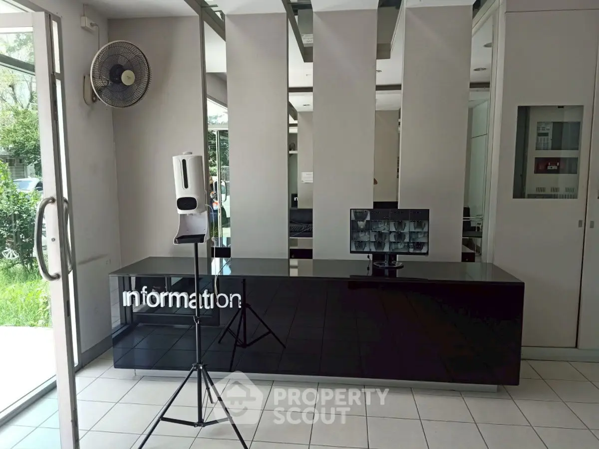 Modern building entrance with sleek information desk and digital display