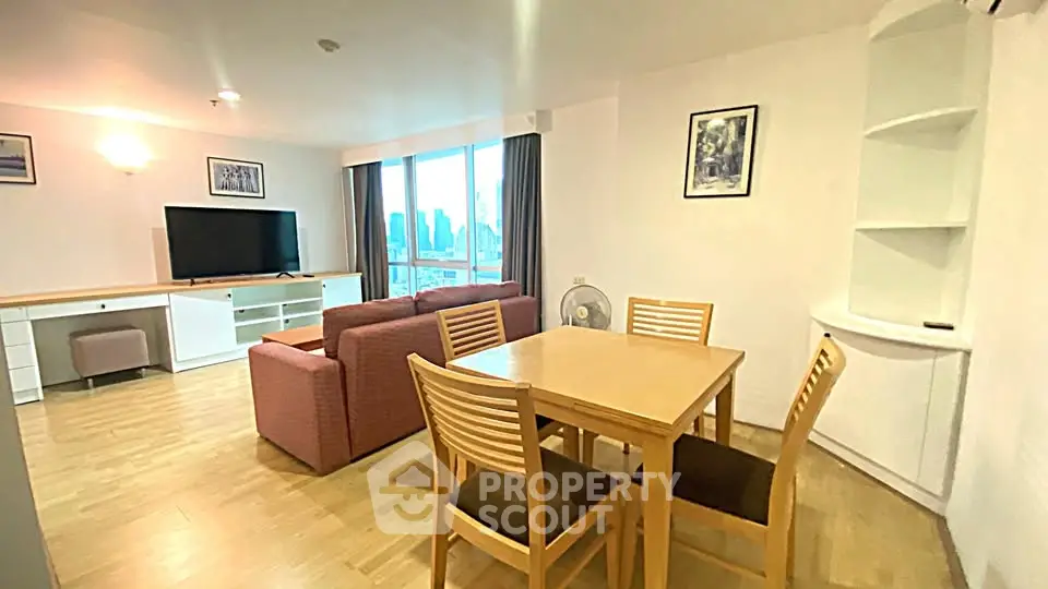 Spacious living room with modern furniture and city view, perfect for urban living.
