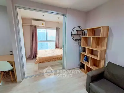 Modern apartment interior with cozy bedroom and stylish living area featuring wooden shelves and large window view.