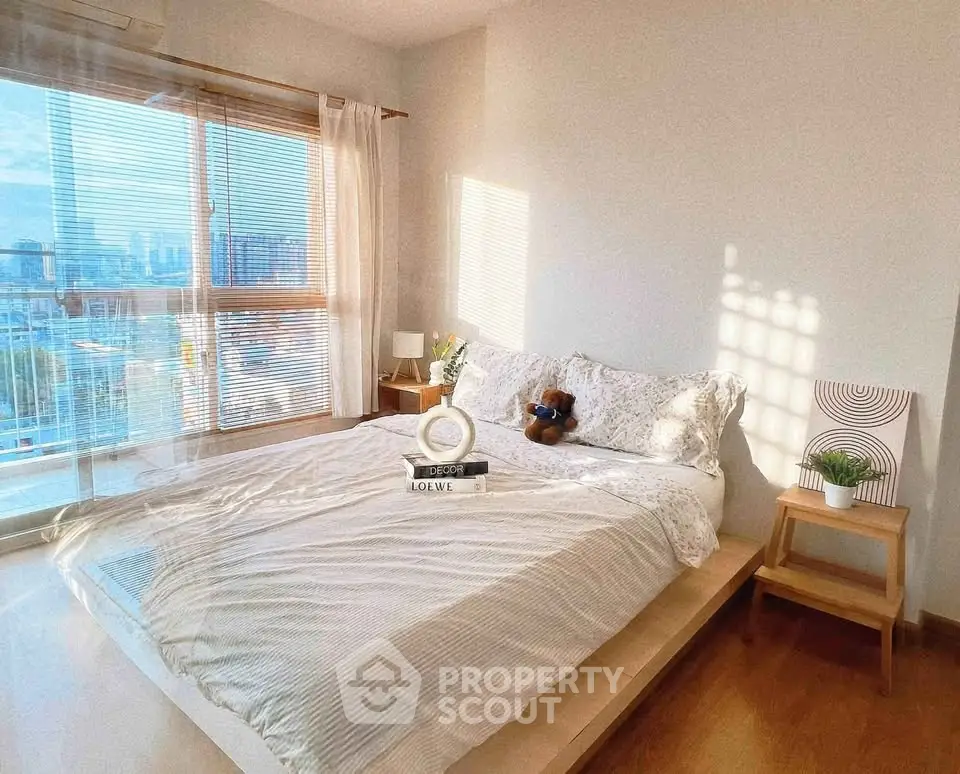 Bright and cozy bedroom with city view and stylish decor