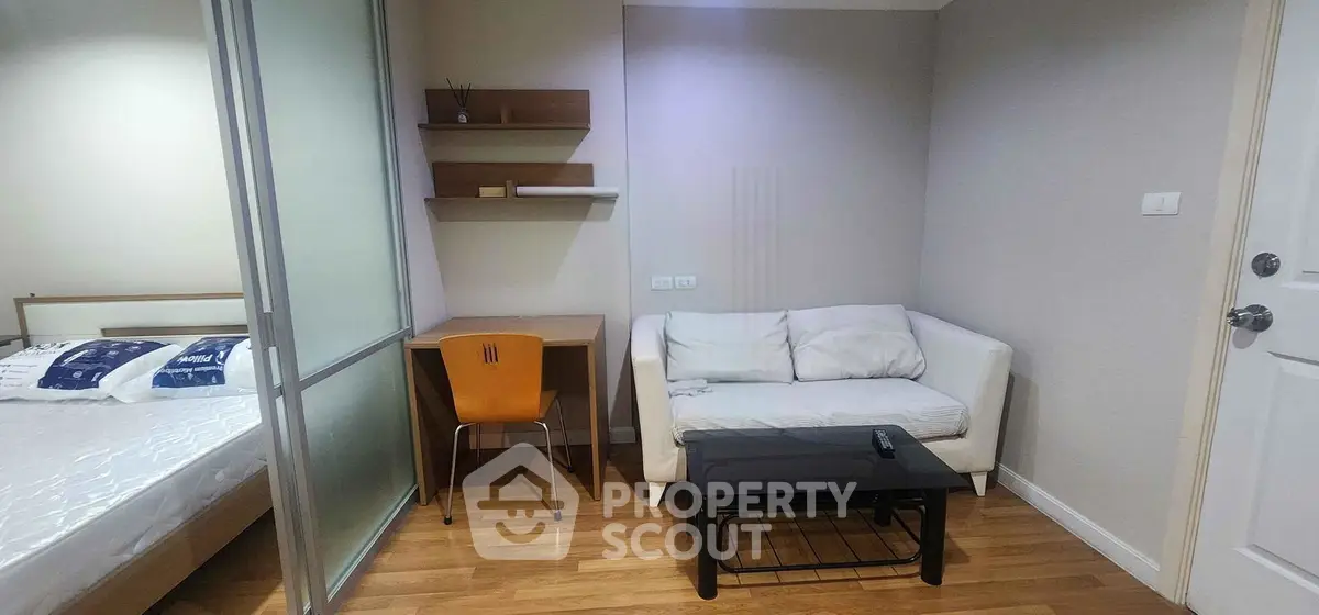 Cozy studio apartment with modern furnishings and wooden flooring