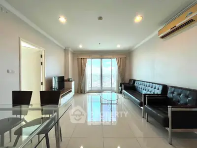 Spacious modern living room with sleek furniture and city view from large windows.