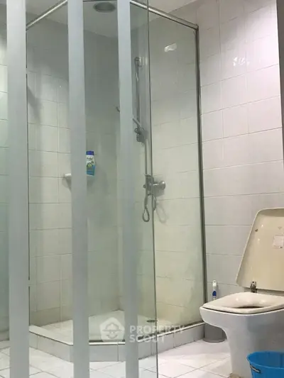 Modern bathroom with glass shower and white tiles