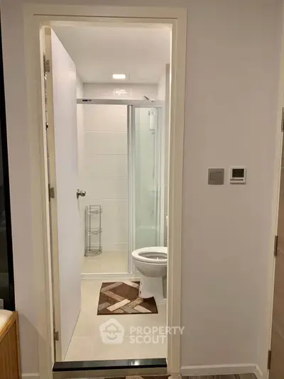 Modern bathroom with glass shower and stylish decor in a contemporary apartment.