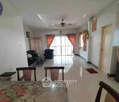Spacious living room with elegant dining area and large windows for natural light.
