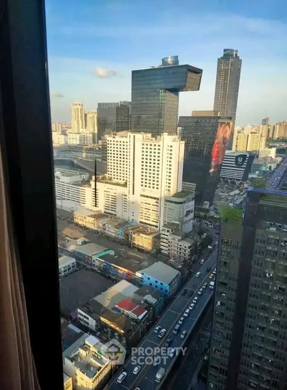 Stunning cityscape view from high-rise building window, showcasing urban skyline and bustling streets below.