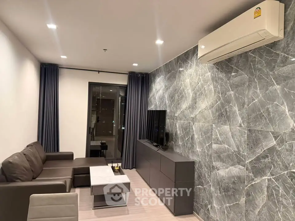 Modern living room with sleek marble accent wall and cozy seating area