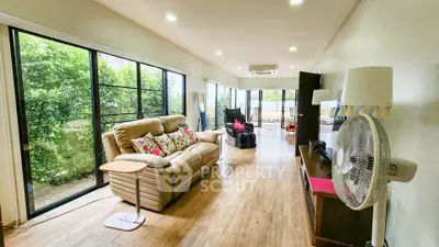 Spacious living room with large windows and modern decor