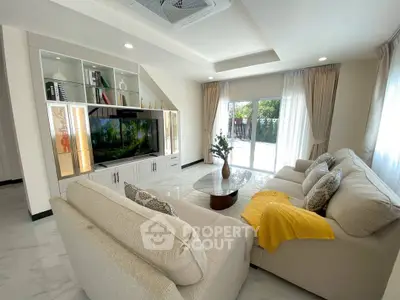 Spacious living room with modern decor and large windows for natural light.