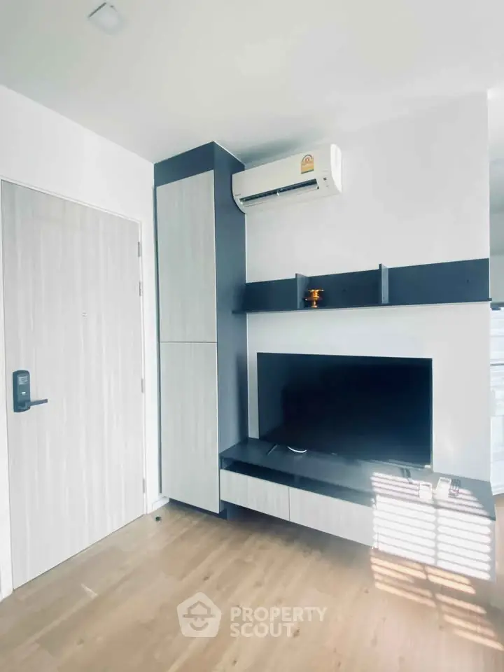Modern living room with sleek TV setup and air conditioning